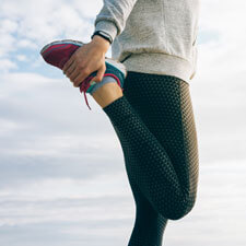 woman stretching with walking shoes